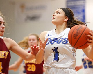 Poland's Brooke Bobbey looks towards the net while Mooney's Camden Hergenrother tries to block her during their game at Poland on Thursday night. EMILY MATTHEWS | THE VINDICATOR