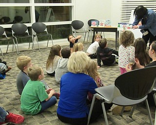 Neighbors | Jessica Harker.Children gathered to listen to Austintown Librarian Mary Lee read stories during the libraries Imagine With Us literacy program Dec. 12.