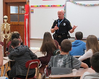 Neighbors | Jessica Harker.Poland Police Officer Steve Kent addressed students at Poland Middle School's Career Day Dec. 14.