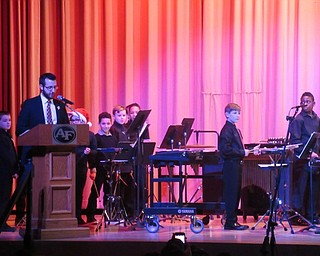 Neighbors | Jessica Harker.Jeremy McClaine, Austintown Middle School band director, spoke to the crowd gathered at the Austintown Fitch High School auditorium for the school's annual holiday concert.