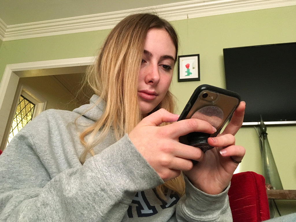 In this Nov. 1, 2018, photo, Laurel Foster holds her phone in San Francisco. Foster is among teens involved in Stanford University research testing whether smartphones can be used to help detect depression and potential self-harm.