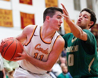 Ursuline's Devan Keevey tries to block Cardinal Mooney's Anthony Fire during their game at Cardinal Mooney on Friday night. EMILY MATTHEWS | THE VINDICATOR