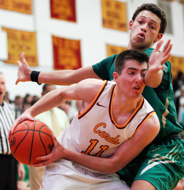 Ursuline's Devan Keevey tries to block Cardinal Mooney's Anthony Fire during their game at Cardinal Mooney on Friday night. EMILY MATTHEWS | THE VINDICATOR