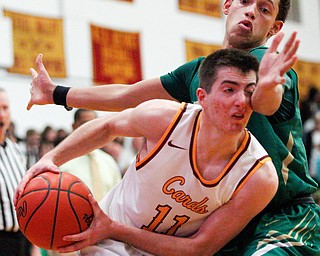 Ursuline's Devan Keevey tries to block Cardinal Mooney's Anthony Fire during their game at Cardinal Mooney on Friday night. EMILY MATTHEWS | THE VINDICATOR