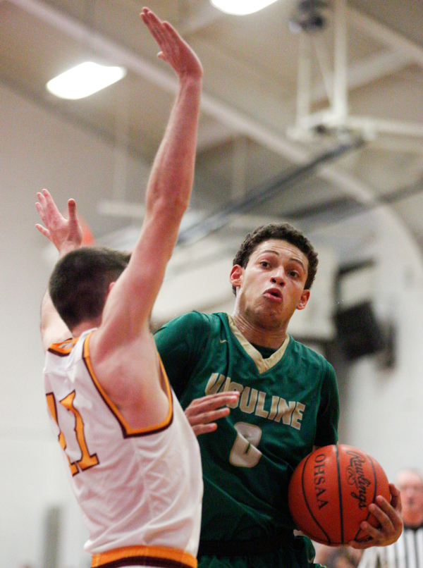 Ursuline's Devan Keevey tries to get past Cardinal Mooney's Anthony Fire during their game at Cardinal Mooney on Friday night. EMILY MATTHEWS | THE VINDICATOR