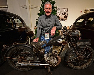 WARREN, OHIO - JANUARY 4, 2018: William Alford,of Canton, poses for a portrait with his Royal Enfield  Flying Flea during the preview party for 19th annual vintage motorcycle exhibit at the National Packard Museum. DAVID DERMER | THE VINDICATOR