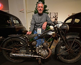 WARREN, OHIO - JANUARY 4, 2018: William Alford, of Canton, poses for a portrait with his Royal Enfield  Flying Flea during the preview party for 19th annual vintage motorcycle exhibit at the National Packard Museum. DAVID DERMER | THE VINDICATOR