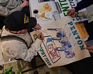 WARREN, OHIO - JANUARY 4, 2018: John Penton, of Amherst, Ohio, signs an autograph for a fan during the preview party for 19th annual vintage motorcycle exhibit at the National Packard Museum. DAVID DERMER | THE VINDICATOR