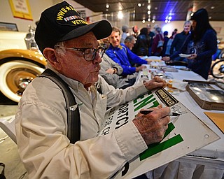 WARREN, OHIO - JANUARY 4, 2018: John Penton, of Amherst, Ohio, signs an autograph for a fan during the preview party for 19th annual vintage motorcycle exhibit at the National Packard Museum. DAVID DERMER | THE VINDICATOR