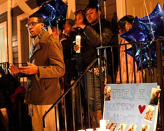 Pastor Todd Johnson of Second Baptist Church in Warren speaks at a vigil for Matthew Burroughs outside of Burroughs' Royal Mall Apartment on Saturday night. EMILY MATTHEWS | THE VINDICATOR