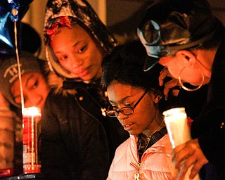 Jayla Burroughs, 8, the daughter of Matthews Burroughs, speaks at a vigil for her father outside of his Royal Mall Apartment on Saturday night. EMILY MATTHEWS | THE VINDICATOR