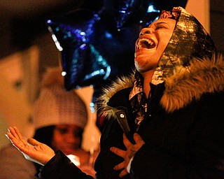 Tara Elkins, the girlfriend of Matthew Burroughs, sings His Eye is on the Sparrow, a song she said Burroughs liked, at a vigil for Burroughs outside of his Royal Mall Apartment on Saturday night. EMILY MATTHEWS | THE VINDICATOR