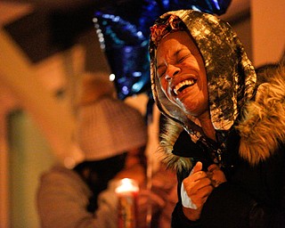 Tara Elkins, the girlfriend of Matthew Burroughs, sings His Eye is on the Sparrow, a song she said Burroughs liked, at a vigil for Burroughs outside of his Royal Mall Apartment on Saturday night. EMILY MATTHEWS | THE VINDICATOR