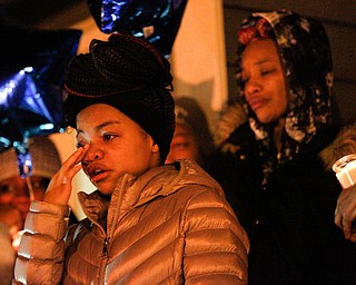 Ashantee Allen, 15, of Warren, speaks about her relationship with Matthew Burroughs as well as how she will miss seeing how happy Burroughs made her mom, Tara Elkins, who is standing behind her, at a vigil for Burroughs outside of his Royal Mall Apartment on Saturday night. EMILY MATTHEWS | THE VINDICATOR