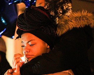 Ashantee Allen, 15, of Warren, speaks about her relationship with Matthew Burroughs as well as how she will miss seeing how happy Burroughs made her mom, Tara Elkins, who is hugging her, at a vigil for Burroughs outside of his Royal Mall Apartment on Saturday night. EMILY MATTHEWS | THE VINDICATOR