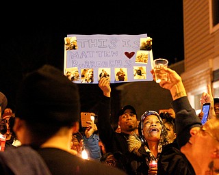 People react after releasing balloons for Matthew Burroughs at the end of a vigil for Burroughs outside of his Royal Mall Apartment on Saturday night. EMILY MATTHEWS | THE VINDICATOR