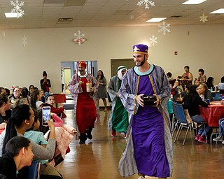 The Three Kings, Carlos Rosario, front, George Lopez, back left, and Jose Rene Vazquez, back right, all of Youngstown, walk in during Three Kings Day at OCCHA on Saturday afternoon. EMILY MATTHEWS | THE VINDICATOR