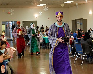 The Three Kings, Carlos Rosario, front, George Lopez, back left, and Jose Rene Vazquez, back right, all of Youngstown, walk in during Three Kings Day at OCCHA on Saturday afternoon. EMILY MATTHEWS | THE VINDICATOR