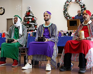 The Three Kings from left, Jose Rene Vazquez, Carlos Rosario, and George Lopez, all of Youngstown, wait to hand out presents during Three Kings Day at OCCHA on Saturday afternoon. EMILY MATTHEWS | THE VINDICATOR