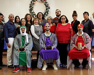 Volunteers and organizers of the Three Kings Day at OCCHA including the Three Kings, from left, Jose Rene Vazquez, Carlos Rosario, and George Lopez, all of Youngstown, pose for a photo after the kings distribute presents to children on Saturday afternoon. EMILY MATTHEWS | THE VINDICATOR