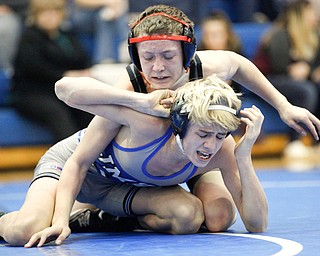 Salem's Tony Seddon, top, tries to pin down Jackson Milton's Austin Stanke during the Jackson-Milton Invitational finals on Saturday. EMILY MATTHEWS | THE VINDICATOR