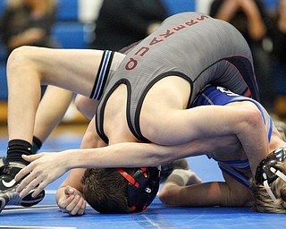 Jackson Milton's Austin Stanke, bottom, and Salem's Tony Seddon wrestle during the Jackson-Milton Invitational finals on Saturday. EMILY MATTHEWS | THE VINDICATOR