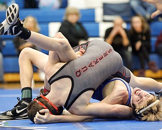 Jackson Milton's Austin Stanke, bottom, and Salem's Tony Seddon wrestle during the Jackson-Milton Invitational finals on Saturday. EMILY MATTHEWS | THE VINDICATOR