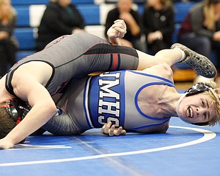 Jackson Milton's Austin Stanke, bottom, and Salem's Tony Seddon wrestle during the Jackson-Milton Invitational finals on Saturday. EMILY MATTHEWS | THE VINDICATOR