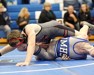 Jackson Milton's Austin Stanke, bottom, and Salem's Tony Seddon wrestle during the Jackson-Milton Invitational finals on Saturday. EMILY MATTHEWS | THE VINDICATOR