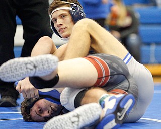 Rootsown's Trent Duvall, right, and Girard's Alex Delgarbino wrestle during the Jackson-Milton Invitational finals on Saturday. EMILY MATTHEWS | THE VINDICATOR