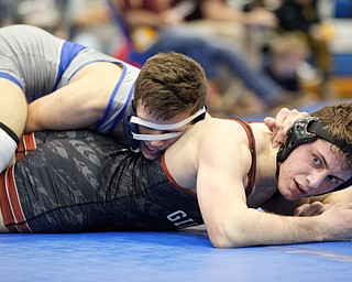 Girard's Alex Delgarbino, left, and Rootsown's Trent Duvall wrestle during the Jackson-Milton Invitational finals on Saturday. EMILY MATTHEWS | THE VINDICATOR