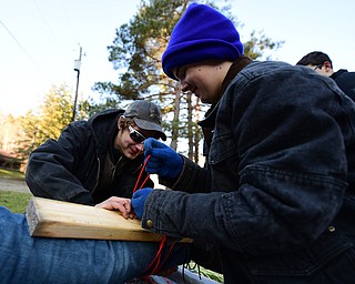 CANFIELD, OHIO - JANUARY 5, 2019: Kyle Ramhoff, front, and Austin Ladd work on putting on a make shift spent on the leg of Nick Martin, Saturday morning at Camp Stambaugh. DAVID DERMER | THE VINDICATOR