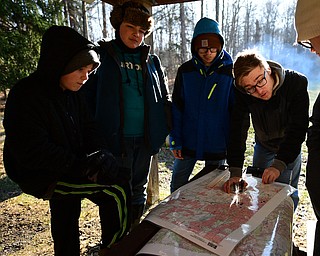 CANFIELD, OHIO - JANUARY 5, 2019: CANFIELD, OHIO - JANUARY 5, 2019: (RtoL) Dylan Jacobs uses a compass while Jonathan Oles, Dylan Hovanes and Dustin Jacobs watch, Saturday morning at Camp Stambaugh. DAVID DERMER | THE VINDICATOR