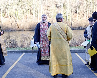 From left, Father Andrew Nelko, Father Tom Constantine, Deacon David Gemmel, Father Dan Roham, and Father Joseph Distefano, members of the Eastern Orthodox Clergy Association of Mahoning County, talk before the start of the Blessing of the Waters Service at Lake Glacier in Mill Creek Park on Sunday afternoon. EMILY MATTHEWS | THE VINDICATOR