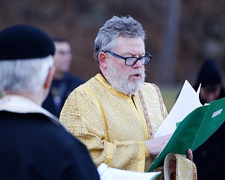 Deacon David Gemmel reads during the Blessing of the Waters Service at Lake Glacier in Mill Creek Park on Sunday afternoon. EMILY MATTHEWS | THE VINDICATOR