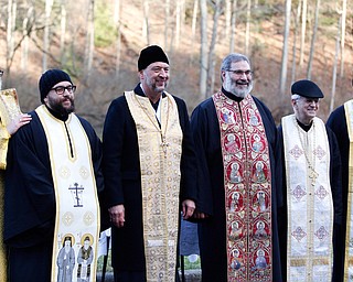 From left, Deacon David Gemmel, Father Michael Gavirols, Father, Andrew Nelko, Father, Tom Constantine, Father Dan Roham, and Father Joseph Distefano, members of the Eastern Orthodox Clergy Association of Mahoning County, pose for a photo at the end of the Blessing of the Waters Service at Lake Glacier in Mill Creek Park on Sunday afternoon. EMILY MATTHEWS | THE VINDICATOR