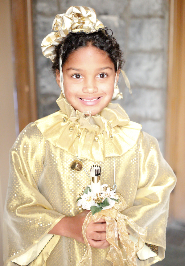 Eva Pandone, 7, of Liberty, dressed as a Christmas sprite poses for a photo before the beginning of the Boar's Head and Yule Log Festival at St. John's Episcopal Church on Sunday afternoon. EMILY MATTHEWS | THE VINDICATOR