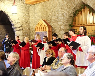 Member of the St. John's Choir perform in the back of the church during the Boar's Head and Yule Log Festival at St. John's Episcopal Church on Sunday afternoon. EMILY MATTHEWS | THE VINDICATOR