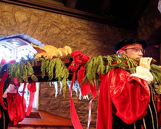 The boar's head is carried into the church during the Boar's Head and Yule Log Festival at St. John's Episcopal Church on Sunday afternoon. EMILY MATTHEWS | THE VINDICATOR