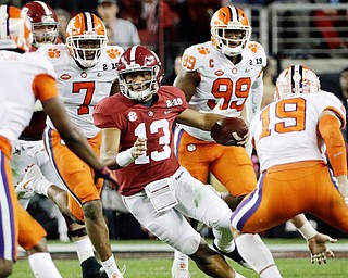 Heisman Trophy runner-up Tua Tagovailoa, 13, from Alabama tries to elude several Clemson Tiger defenders during the College Football Playoff national championship game at Levi's Stadium in Santa Clara, Calif. The Tigers crushed the Crimson Tide 44-16 on Monday night to win its second national championship in three years and handed Crimson Side Coach Nick Saban his most lopsided defeat.