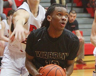 William D. Lewis The Vindicator  Harding's D'Muntzie Owens(10) looks to the hoop as Canfield's Kyle Gamble (24) defends during 1-8-19 action at Canfield.