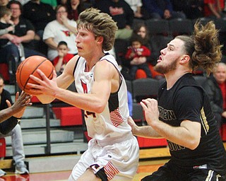 William D. Lewis The Vindicator Canfield's Kyle Gamble (24) drives to the hoop s Harding's William McCready(5) defends during 1-8-19 action at Canfield.