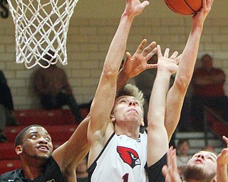 William D. Lewis The Vindicator Canfield's Aydin Hanouser(1) tries for 2 as Harding's Aston Bates(1) and William McCready(5)defend during 1-8-19 action at Canfield.