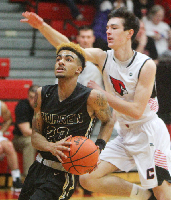 William D. Lewis The Vindicator  Harding's Dom McGee(23)) looks to the hoop as Canfield'sBrayden Beck(3) defends during 1-8-19 action at Canfield.