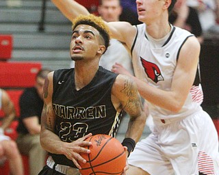 William D. Lewis The Vindicator  Harding's Dom McGee(23)) looks to the hoop as Canfield'sBrayden Beck(3) defends during 1-8-19 action at Canfield.