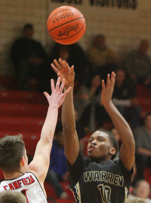 William D. Lewis The Vindicator  Harding's D'Muntzie Owens(10) looks to the hoop as Canfield'sJake Kowal(4) defends during 1-8-19 action at Canfield.