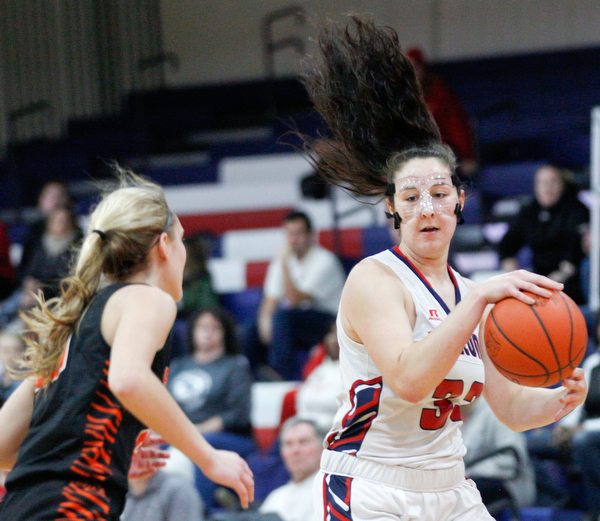 Fitch's Sabria Hunter dribbles the ball while Howland's Alex Ochman comes up to try to block her during the first half of their game at Fitch High School on Wednesday night. EMILY MATTHEWS | THE VINDICATOR