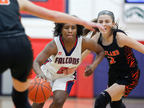 Fitch's Jada Lazaro dribbles the ball while Howland's Ashley Chambers, right, and Jenna Craigo, left, try to block her during the first half of their game at Fitch High School on Wednesday night. EMILY MATTHEWS | THE VINDICATOR