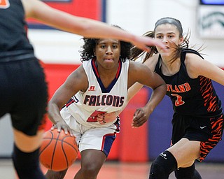 Fitch's Jada Lazaro dribbles the ball while Howland's Ashley Chambers, right, and Jenna Craigo, left, try to block her during the first half of their game at Fitch High School on Wednesday night. EMILY MATTHEWS | THE VINDICATOR