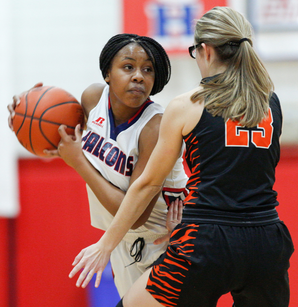 Fitch's Daria Williams looks to pass the ball while Howland's Makayla Dahman tries to block her during the first half of their game at Fitch High School on Wednesday night. EMILY MATTHEWS | THE VINDICATOR